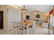 Living room with tile floors, light walls, and access to dining area at 9664 Lake Douglas Pl, Orlando, FL 32817