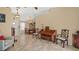 Spacious living room adjacent to the dining area featuring a piano and views of the foyer at 9664 Lake Douglas Pl, Orlando, FL 32817