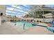 Screened-in pool area with a large pool and spa, surrounded by lush landscaping at 9664 Lake Douglas Pl, Orlando, FL 32817