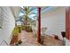 Charming outdoor patio with wicker furniture, patterned tile, and lush landscaping at 9664 Lake Douglas Pl, Orlando, FL 32817