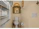 Toilet room featuring a small, decorated window and tile floors at 9664 Lake Douglas Pl, Orlando, FL 32817