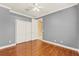 Neutral bedroom with hardwood floors and a spacious double door closet at 1000 Parasol Pl, Oviedo, FL 32766