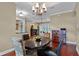 Dining room view showing the hardwood floors, chandelier and layout of this inviting home at 120 W Magnolia Ave, Howey In The Hills, FL 34737