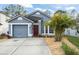 Cute blue house with attached garage and nicely landscaped front yard at 1261 Martin Blvd, Orlando, FL 32825