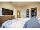 Cozy bedroom featuring a dresser with a large TV and a walk-in closet for ample storage at 1341 Arbor Vista Loop # 321, Lake Mary, FL 32746
