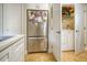 Bright laundry area with stainless steel refrigerator and a washer and dryer at 1341 Arbor Vista Loop # 321, Lake Mary, FL 32746
