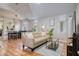 Bright living room featuring wood floors, a neutral sofa, and dining area at 1341 Arbor Vista Loop # 321, Lake Mary, FL 32746