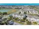 Aerial view of a well-maintained community with townhomes, a pond, and mature trees at 13829 Ingelnook Dr, Windermere, FL 34786