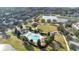 Aerial view of a community with a lake, green spaces, a clubhouse, and a pool at 13829 Ingelnook Dr, Windermere, FL 34786