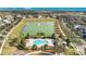 Aerial view of a community with a lake, fountain, community pool, clubhouse, and playground at 13829 Ingelnook Dr, Windermere, FL 34786