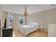 Bright bedroom featuring hardwood floors, neutral walls, and a decorative chandelier, providing a serene atmosphere at 13829 Ingelnook Dr, Windermere, FL 34786
