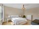 Cozy bedroom featuring hardwood floors, a decorative chandelier, and ample natural light, creating a relaxing space at 13829 Ingelnook Dr, Windermere, FL 34786