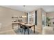 Modern dining area with dark wood table, chairs, and stylish lighting fixture at 13829 Ingelnook Dr, Windermere, FL 34786