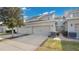 View of attached two-car garage with neutral paint, driveway, and nearby landscaping at 13829 Ingelnook Dr, Windermere, FL 34786