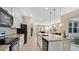 Bright kitchen with granite counters, stainless appliances, and large island open to the living and dining areas at 13829 Ingelnook Dr, Windermere, FL 34786