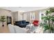 Open-concept living room featuring tile flooring, large windows, and comfortable seating at 13829 Ingelnook Dr, Windermere, FL 34786