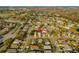 Wide aerial shot of a residential neighborhood with homes, streets, trees, and lake in the distance at 14607 Traders Path, Orlando, FL 32837