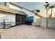 A cozy brick back patio with a grill, comfortable seating, and screened-in area, perfect for outdoor entertaining at 14607 Traders Path, Orlando, FL 32837