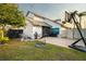 A spacious backyard with a brick patio, grill, green grass, a basketball hoop, and a fire pit at 14607 Traders Path, Orlando, FL 32837
