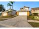 Charming two-story home featuring a two-car garage, brick accents, mature landscaping, and a well-maintained lawn at 14607 Traders Path, Orlando, FL 32837