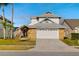 Charming two-story home featuring a two-car garage, brick accents, mature landscaping, and a well-maintained lawn at 14607 Traders Path, Orlando, FL 32837