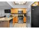 Well-lit kitchen features granite countertops, a breakfast bar, and modern stainless steel appliances at 14607 Traders Path, Orlando, FL 32837