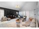 Bright living room boasts tile flooring, neutral decor, and ample natural light from large windows at 14607 Traders Path, Orlando, FL 32837