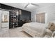 Stylish bedroom features tiled flooring, a sleek accent wall, and ample storage solutions at 14607 Traders Path, Orlando, FL 32837