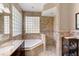 Elegant bathroom with soaking tub, walk-in shower, and granite vanity at 14872 Faversham Cir, Orlando, FL 32826