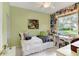 Bedroom with daybed, desk, and window overlooking backyard at 14872 Faversham Cir, Orlando, FL 32826