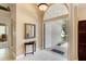 View of entryway with mirror, console table, and door to exterior at 14872 Faversham Cir, Orlando, FL 32826