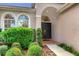 Front entry with double doors and manicured landscaping at 14872 Faversham Cir, Orlando, FL 32826