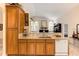 Kitchen boasts a large island with granite countertops and wood cabinets at 14872 Faversham Cir, Orlando, FL 32826