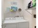 Convenient laundry room with washer, dryer, and ample shelving at 14872 Faversham Cir, Orlando, FL 32826