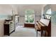 Home office with piano, built-in shelving, and plenty of natural light at 14872 Faversham Cir, Orlando, FL 32826