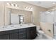 Modern bathroom with double vanity and a shower at 153 Villa Domani Cir, Davenport, FL 33896