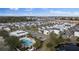 Aerial view of the community featuring the pool, modern homes, and surrounding landscape at 153 Villa Domani Cir, Davenport, FL 33896