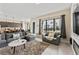 Open living room with sectional sofa and large windows at 153 Villa Domani Cir, Davenport, FL 33896