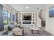 Bright living room features a modern fireplace and large windows at 153 Villa Domani Cir, Davenport, FL 33896