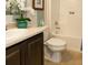 Clean bathroom with dark wood vanity, tile floor, and bathtub shower combo at 1575 Weaver Oak Way, Deland, FL 32720