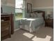 Bright bedroom featuring a full bed, large window, and wood furniture at 1575 Weaver Oak Way, Deland, FL 32720