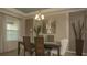 Elegant dining room with a decorative mirror and hardwood floors at 1575 Weaver Oak Way, Deland, FL 32720