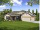 One-story house with a two-car garage and landscaped lawn at 1575 Weaver Oak Way, Deland, FL 32720