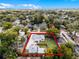 An aerial view with property lines, showcasing a single-Gathering home and detached garage surrounded by green trees and city views at 1911 Canton St, Orlando, FL 32803