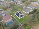 Aerial view of a property with solar panels, spacious backyard, and a swimming pool in the neighborhood at 2029 Knollcrest Dr, Clermont, FL 34711