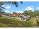 Spacious backyard featuring a well-manicured lawn and solar panels on the roof at 2029 Knollcrest Dr, Clermont, FL 34711