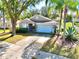 Charming single-story home with a well-manicured lawn, mature trees, and a two-car garage, set in a tranquil neighborhood at 2029 Knollcrest Dr, Clermont, FL 34711