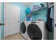 Convenient laundry room features a modern washer and dryer and ample shelving for storage at 2029 Knollcrest Dr, Clermont, FL 34711