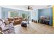 Spacious living room with comfortable seating, a ceiling fan, and a sliding glass door leading to the outdoors at 2029 Knollcrest Dr, Clermont, FL 34711