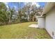 Large backyard offers ample green space and mature trees, enclosed by a chain-link fence at 2049 Jefferson Ave, Deltona, FL 32738